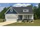 Charming new construction featuring stone accents, a covered entryway, and a two-car garage at 42 Hemming Ct, Cameron, NC 28326