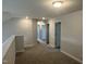 A carpeted upstairs hallway featuring neutral walls and white doors offers a bright transition between rooms at 42 Hemming Ct, Cameron, NC 28326
