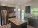 Kitchen featuring stainless appliances, granite countertops, tile backsplash, and access to backyard deck at 42 Hemming Ct, Cameron, NC 28326