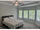 Spacious bedroom featuring a tray ceiling, carpet floors, and plenty of natural light at 42 Hemming Ct, Cameron, NC 28326