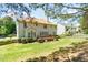 Wide view of back of home featuring a wooden deck, well-kept lawn, and manicured shrubbery with privacy fence at 4404 Triland Way, Cary, NC 27518