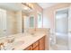 Bathroom with double sinks, vanity with wood cabinets, and a framed mirror at 4404 Triland Way, Cary, NC 27518