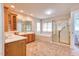 Spacious bathroom with dual sinks, large mirrors, and a separate tub and shower at 4404 Triland Way, Cary, NC 27518
