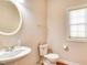 Cozy bathroom with a single sink, round mirror, and natural light from the window at 4404 Triland Way, Cary, NC 27518
