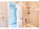 Bright bathroom with a shower-tub combo with an adjustable shower head and shelves at 4404 Triland Way, Cary, NC 27518
