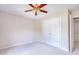 A bright bedroom featuring double door closet and a ceiling fan at 4404 Triland Way, Cary, NC 27518