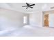 Bright bedroom featuring tray ceiling, ceiling fan, and large window at 4404 Triland Way, Cary, NC 27518