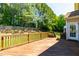 Inviting wood deck offering a view of the lush backyard with mature trees and a privacy fence at 4404 Triland Way, Cary, NC 27518