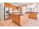 Kitchen with island, stainless steel appliances, wine rack and ample counter space at 4404 Triland Way, Cary, NC 27518