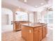 Kitchen boasts island with sink, and an arched entryway, seamlessly connecting to the living spaces at 4404 Triland Way, Cary, NC 27518