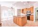 Bright kitchen with large island, stainless steel appliances, recessed lighting, and breakfast area at 4404 Triland Way, Cary, NC 27518