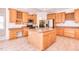 Well-lit kitchen features island, stainless appliances, and breakfast area at 4404 Triland Way, Cary, NC 27518