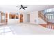 Open-concept living room with fireplace, open to kitchen with archways and entry way with a staircase at 4404 Triland Way, Cary, NC 27518
