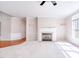 Bright living room with fireplace, neutral carpet, and large window provides comfortable space at 4404 Triland Way, Cary, NC 27518