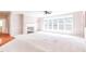 Bright living room with neutral carpet, gas fireplace, crown molding, and multiple windows for natural light at 4404 Triland Way, Cary, NC 27518