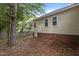 Backyard view with brick foundation and light yellow vinyl siding at 4705 Forest Highland Dr, Raleigh, NC 27604