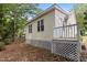 View of the backyard with a white wooden deck and light yellow siding at 4705 Forest Highland Dr, Raleigh, NC 27604