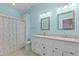 Bathroom featuring double sinks with granite countertops, a shower, and two mirrors at 4705 Forest Highland Dr, Raleigh, NC 27604