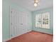 Bedroom featuring a double door closet, and a window bringing in natural light at 4705 Forest Highland Dr, Raleigh, NC 27604