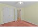 Bedroom features a double door closet, ceiling fan and a view into the hallway at 4705 Forest Highland Dr, Raleigh, NC 27604