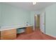 Bedroom featuring a built-in desk with drawers and a view into the hallway at 4705 Forest Highland Dr, Raleigh, NC 27604