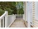 Wooden deck with white railing and light yellow vinyl siding at 4705 Forest Highland Dr, Raleigh, NC 27604