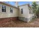 Exterior backyard featuring brick foundation, yellow vinyl siding, and lattice skirting at 4705 Forest Highland Dr, Raleigh, NC 27604