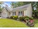 Charming single-story home with manicured lawn and colorful flowerbed at 4705 Forest Highland Dr, Raleigh, NC 27604