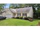 Single-story home with attached garage, verdant lawn, and flowerbed at 4705 Forest Highland Dr, Raleigh, NC 27604