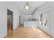 Eat-in kitchen featuring white cabinets and modern lighting at 4705 Forest Highland Dr, Raleigh, NC 27604