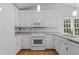 Charming kitchen featuring white cabinets, updated appliances, and a stylish design at 4705 Forest Highland Dr, Raleigh, NC 27604