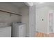 Laundry Room featuring a washer and dryer, shelving, and a view into the hallway at 4705 Forest Highland Dr, Raleigh, NC 27604