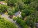 Aerial view of the house and garage on a quiet lot surrounded by mature trees at 4713 Erwin Rd, Durham, NC 27705