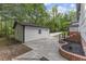 Backyard with a detached garage, manicured landscaping, and a stone walkway at 4713 Erwin Rd, Durham, NC 27705