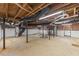 Unfinished basement featuring exposed brick, duct work, and wooden ceiling beams at 4713 Erwin Rd, Durham, NC 27705