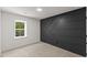 Well-lit bedroom featuring a decorative accent wall, carpeted floors, and a bright window at 4713 Erwin Rd, Durham, NC 27705