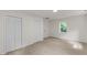Bedroom with neutral carpet, white walls, a window, and access to two closets, offering plenty of storage at 4713 Erwin Rd, Durham, NC 27705