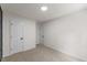 Spacious bedroom features neutral carpet, white walls, and two doors for ample access at 4713 Erwin Rd, Durham, NC 27705