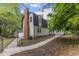 Charming two-story home with brick chimney and a fenced yard offers privacy at 4713 Erwin Rd, Durham, NC 27705