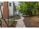 Quaint two-story home with charming walkway lined by lush foliage and a fenced yard at 4713 Erwin Rd, Durham, NC 27705