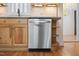 Stainless steel dishwasher with natural wood cabinets and modern countertop at 4713 Erwin Rd, Durham, NC 27705