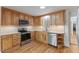 Bright kitchen with stainless steel appliances, wood cabinets, and plenty of counter space at 4713 Erwin Rd, Durham, NC 27705