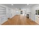 Spacious living room featuring wood floors, built-in shelves, and a cozy fireplace at 4713 Erwin Rd, Durham, NC 27705