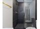 Modern shower featuring black tiling, gold fixtures, and a glass door, with a second toilet visible at 4713 Erwin Rd, Durham, NC 27705