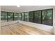 Sunroom offers lots of natural light with many large windows overlooking a wooded yard at 4713 Erwin Rd, Durham, NC 27705