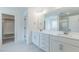 Bathroom with dual vanity, white cabinets, and a large mirror offering a bright and clean space at 48 Sanders Farm Dr, Smithfield, NC 27577