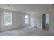 Bright bedroom features tile flooring, two large windows, and doorway to a white tiled bathroom at 48 Sanders Farm Dr, Smithfield, NC 27577