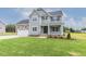 Inviting two-story home featuring a covered front porch and attached two-car garage at 48 Sanders Farm Dr, Smithfield, NC 27577