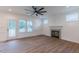Bright living room with wood floors, fireplace, and large windows at 48 Sanders Farm Dr, Smithfield, NC 27577