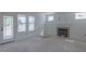 Sunlit living room with modern fireplace, wainscoting, and direct access to the outdoor deck, offering seamless indoor-outdoor living at 48 Sanders Farm Dr, Smithfield, NC 27577